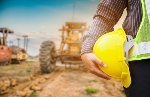 Asian business man construction engineer worker with yellow protective helmet at construction site