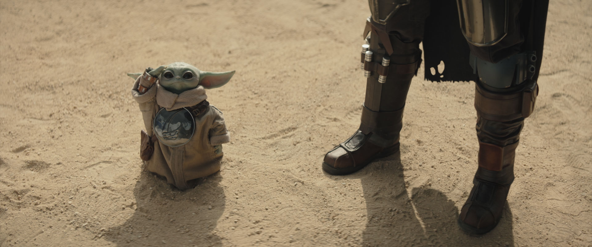 A baby yoda toy next to a person's leg

AI-generated content may be incorrect.